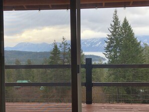 view from main level living room and deck with hot tub