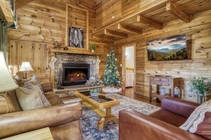 Cozy living space. Large smart TV, wood burning fireplace, queen sleeper couch and a chair that converts into a kid size twin bed