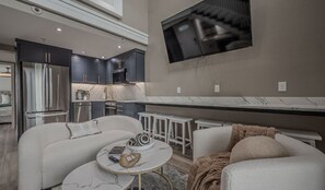 Full kitchen with plenty of storage, 6 bar stools for eating under the TV