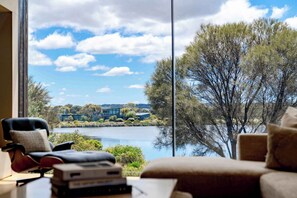 This expansive and modern home offers an unrivalled experience of coastal luxury, panoramic golf course and lake views