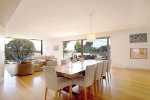 Gather around the sleek dining table for meals or take a seat outside for relaxed alfresco dining