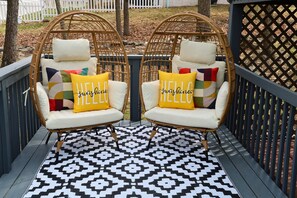 Enjoy this elegant bistro set beneath string lights, perfect for evening chats.
