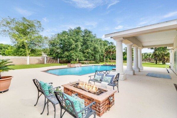 Gas fire pit seating area around the pool