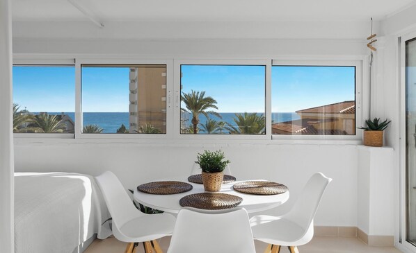 Dining area with Mediterranean view and direct access to the terrace.