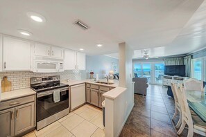 The fully equipped kitchen features quartz countertops and subway tile backsplash and has everything you need to prepare meals for family & friends.
