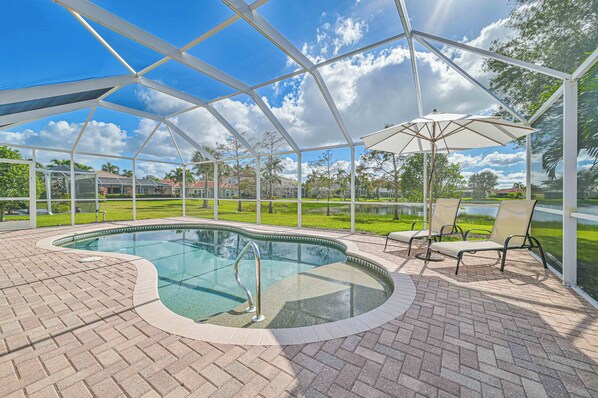 Lake Vista - Enjoy the stunning lake view from the screened in pool area with heated pool