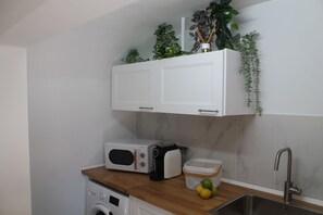Efficiency meets flavor in our cozy kitchenette – your hub for creating delicious meals in a compact space. #CompactCulinary
