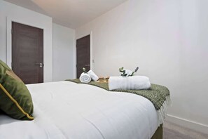 Bedroom 1 benefits from a comfortable double bed, plenty of storage and an en-suite bathroom with a toilet, sink and shower cubicle.