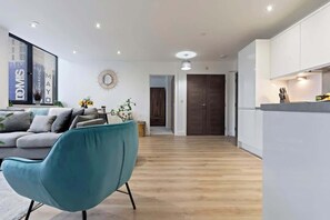 The open-plan living room, dining area and kitchen benefit from a comfortable sofa and 40-inch SMART TV.