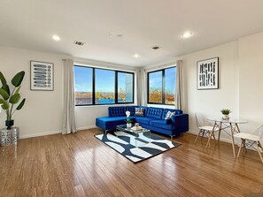 Contemporary Livingroom:
- Sofa
- Blackout curtains 
- City View
- 65" Smart TV