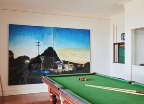 A pool and billiard room complete with cosy seating will keep everyone entertained during relaxed afternoons at home. 