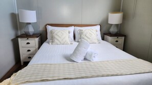 Relax in a cosy bedroom with a queen bed and TV