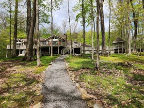 View from lake to back of house with expansive deck