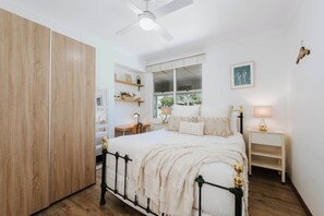 Sleep comfortably in the primary bedroom with a queen bed, built-in robes and ceiling fan.