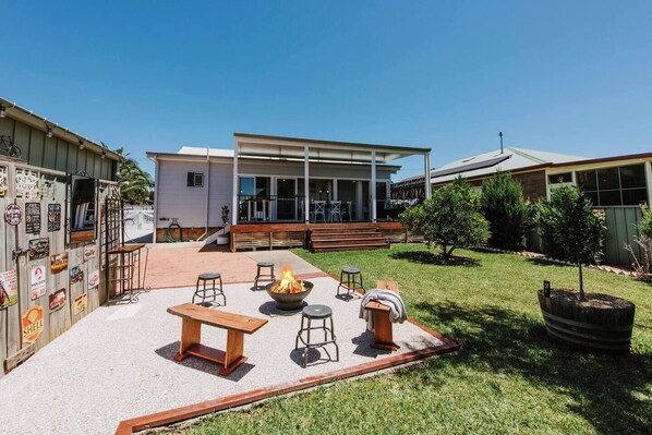 Relax by the fire pit in the spacious backyard, complete with rustic seating and stunning views of the home’s inviting alfresco area.