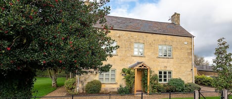 Todenham Farmhouse has a golden glow from its Cotswold stone