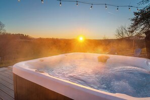 Relax in the hot tub at sunset with a drink in hand