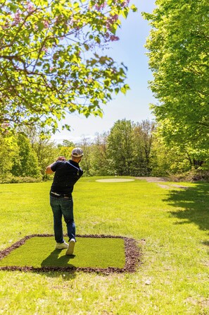 Enjoy your own backyard golf hole with putting green, tee box, and clubs!