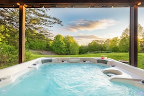 Unwind in a 7-person jacuzzi with lights, jets, and stunning sunset views.