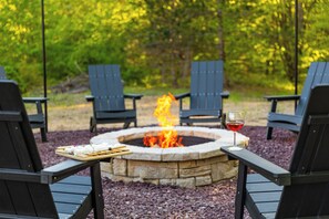 Cozy up by the outdoor firepit with Adirondack chairs, s’mores, wine, and stars.