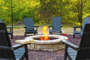 Cozy up by the outdoor firepit with Adirondack chairs, s’mores, wine, and stars.