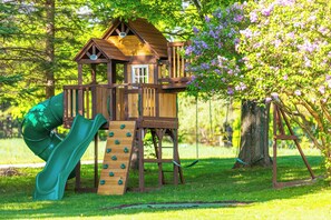 Kids will love the huge backyard playground with slides, swings, and more!