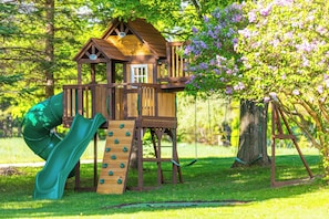 Kids will love the huge backyard playground with slides, swings, and more!