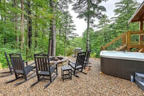 Firepit and hot tub area with great wooded setting
