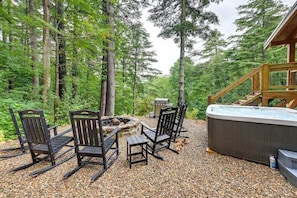Firepit and hot tub area with great wooded setting