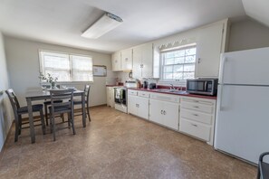 Fully equipped kitchen with appliances with dining table for 4