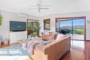 Light filled living room with access to two outdoor areas.