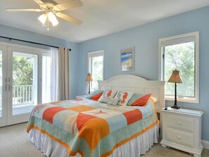 Vibrant and cozy bedroom with large windows that fill the space with natural light, creating a cheerful and relaxing retreat.