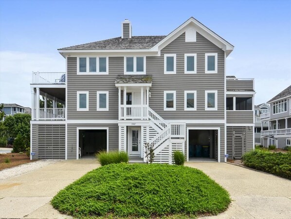 Front view of the home, highlighting its convenient parking, stylish architecture, and proximity to the ocean.