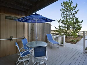 Spacious outdoor patio with seating and an umbrella, ideal for casual meals or relaxing outdoors.