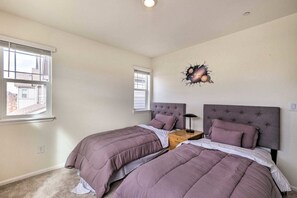 Twin beds with plush linens and soft lighting make this room perfect for children or friends traveling together.