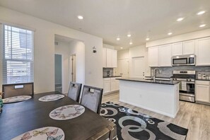 Sleek and spacious kitchen with modern appliances and a dining area for shared meals. Ideal for family gatherings or cozy dinners.