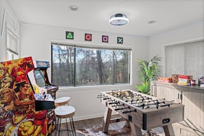 Game room bliss with 2 arcade games, foosball, board games, and a Murphy bed!