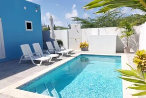 Well-maintained pool area with comfortable lounge chairs.