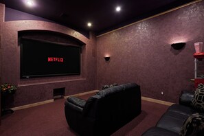 Movie nights reimagined! Dive into cinematic bliss in this cozy home theater, complete with plush seating and an immersive screen experience.