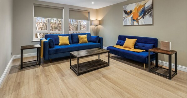 Relax in style in our cozy living room with a comfy sofa – your perfect spot to unwind.