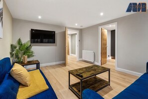 Cozy living room with a comfy sofa and Smart TV – perfect for relaxing and unwinding