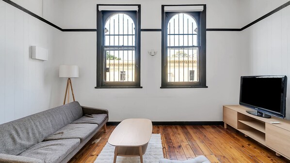 Bright and airy living space with charming arched windows.