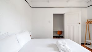 Spacious bedroom with a dedicated workspace for added convenience.