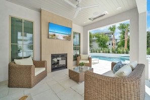 Relax Poolside with The Indoor/Outdoor Fireplace, Catch the Big Game on the TV While the Kids Splash the Night Away