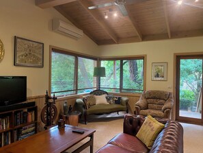 Spacious living room with Smart TV and sound bar. 