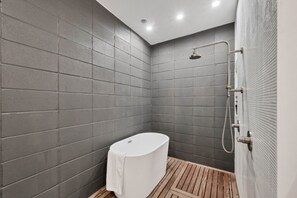 Unwind in our spacious bathroom with modern amenities and a touch of luxury