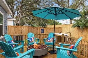 Hot tub and Adirondack-ringed fire pit.