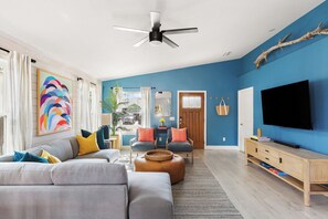65-inch smart TV and large-sectional sofa.