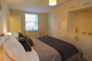 Relax in timeless elegance – the master bedroom offers traditional charm and ultimate comfort