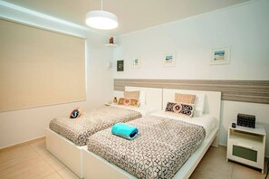 A serene space with a comfortable king-sized bed, soft linens, and plenty of natural light for a restful retreat.